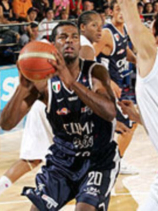 Jugador de baloncesto en acción durante un partido, vestido con uniforme azul y blanco, controlando el balón.
