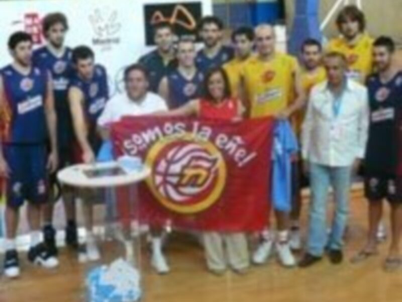 Equipo de baloncesto posando con una bandera de Suiza en un partido.
