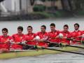 Equipo de remo en una competición, remando juntos en un barco de ocho personas.