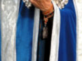 Man wearing a blue robe with silver and white details, holding a silver object.