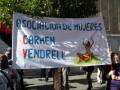 Banner de la Asociación de Mujeres Carmen Vendrell con un dibujo de una mujer sentada en el suelo.